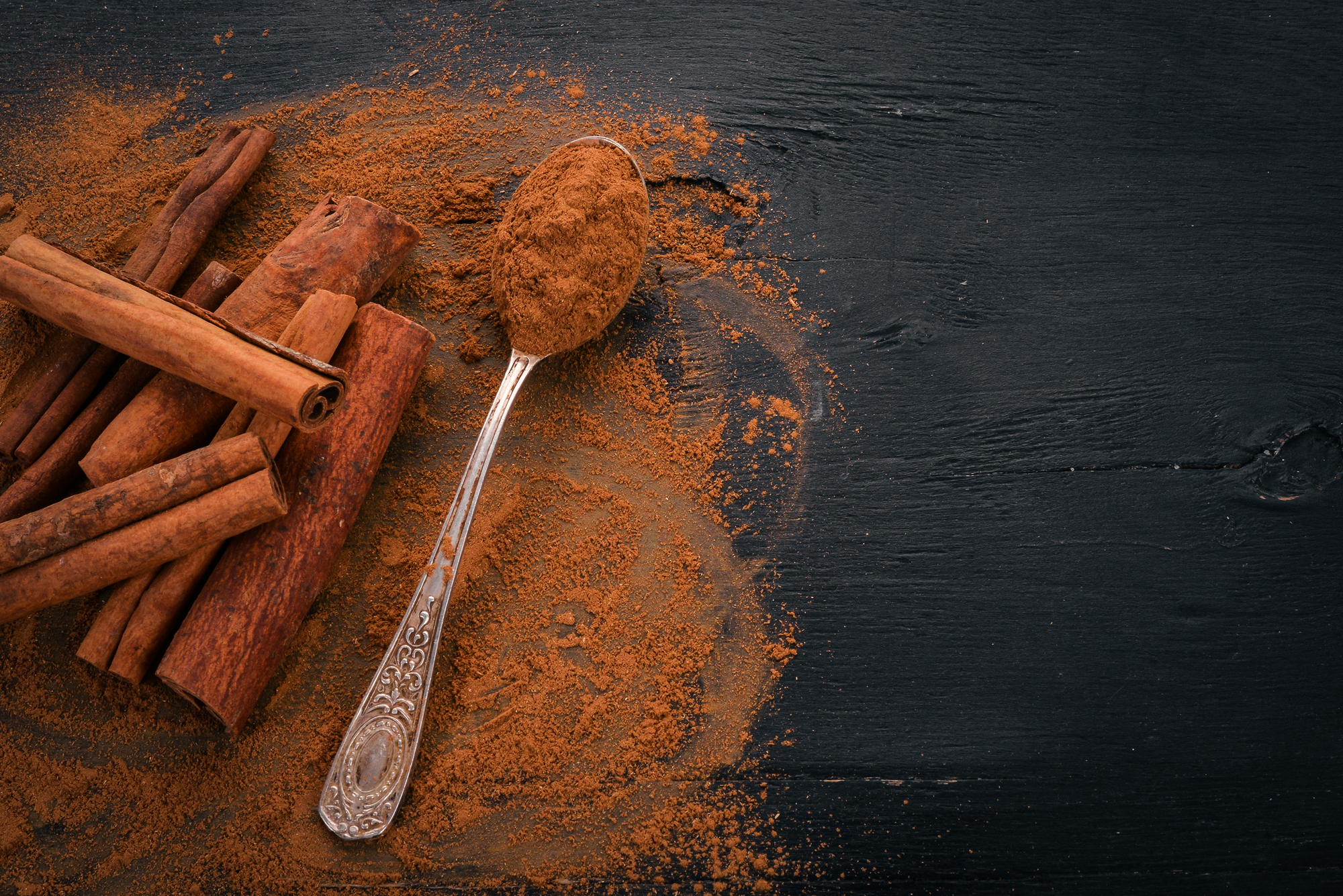 cinnamon-black-wooden-background-free-space-text-top-view (2)